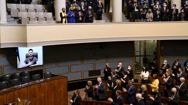 Finnish MP's listen to Ukrainian President Volodymyr Zelenskiy during his virtual address to the Finnish Parliament, amid Russia's invasion of Ukraine, in Helsinki, Finland, April 8, 2022. (Reuters)
