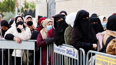 Palestinians make their way through an Israeli checkpoint to attend the first Friday prayers of Ramadan in Jerusalem's Al-Aqsa Mosque, April 8, 2022. (Reuters)