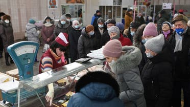 Customers line up next to a counter at a market in Omsk, Russia on February 18, 2022. (Reuters)