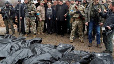 European Commission President Ursula von der Leyen, High Representative of the European Union for Foreign Affairs and Security Policy Josep Borrell and Slovakia's Prime Minister Eduard Heger stand next to bodies that were exhumed from a mass grave as they visit the town of Bucha, as Russia's attack on Ukraine continues, outside of Kyiv, Ukraine April 8, 2022. REUTERS/Valentyn Ogirenko
