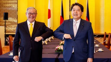 Philippine Foreign Secretary Teodoro Locsin and Japanese Foreign Minister Yoshimasa Hayashi pose for photographs at the Iikura Guest House, Tokyo, Japan April 9, 2022. (Reuters)