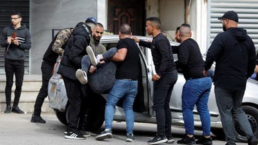 People carry a Palestinian wounded during clashes with Israeli forces, in Jenin in the Israeli-occupied West Bank on April 9, 2022. (Reuters)