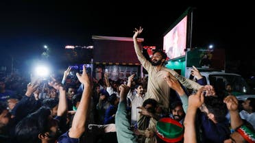 Supporters of the Pakistan Tehreek-e-Insaf (PTI) political party dance as they attend a rally in support of Pakistani Prime Minister Imran Khan, in Islamabad, Pakistan April 4, 2022. (Reuters)