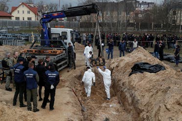 Forensic technicians exhume the bodies of civilians who Ukrainian officials say were killed during Russia’s invasion and then buried in a mass grave in the town of Bucha, outside Kyiv, Ukraine on April 8, 2022. (Reuters)