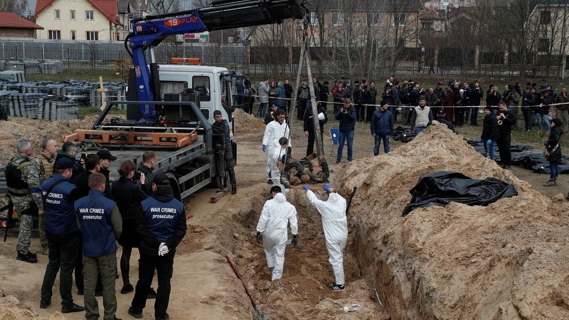 Forensic technicians exhume the bodies of civilians who Ukrainian officials say were killed during Russia’s invasion and then buried in a mass grave in the town of Bucha, outside Kyiv, Ukraine on April 8, 2022. (Reuters)