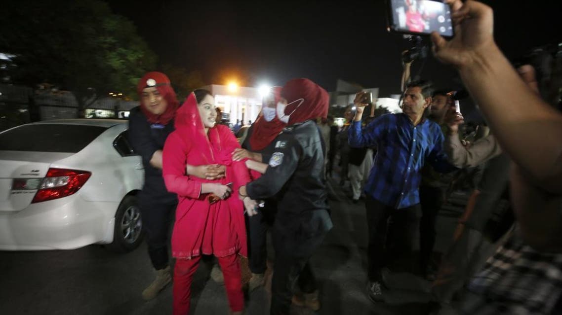 Police officers detain a supporter of Pakistan's Prime Minister Imran Khan outside the National Assembly after a no-confidence vote, in Islamabad, Pakistan, early Sunday, April 10, 2022. (AP)