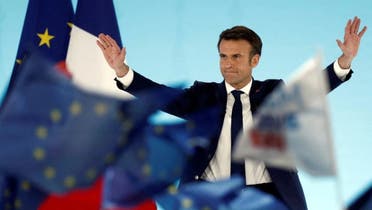 French President Emmanuel Macron, candidate for his re-election, reacts on stage after partial results in the first round of the 2022 French presidential election, in Paris, France, on April 10, 2022. (Reuters)