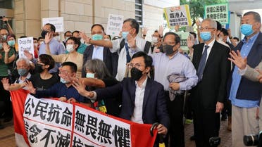 Pro-democracy activists chant slogans outside the West Kowloon Magistrates Court, in Hong Kong, China, on May 18, 2020. (Reuters)