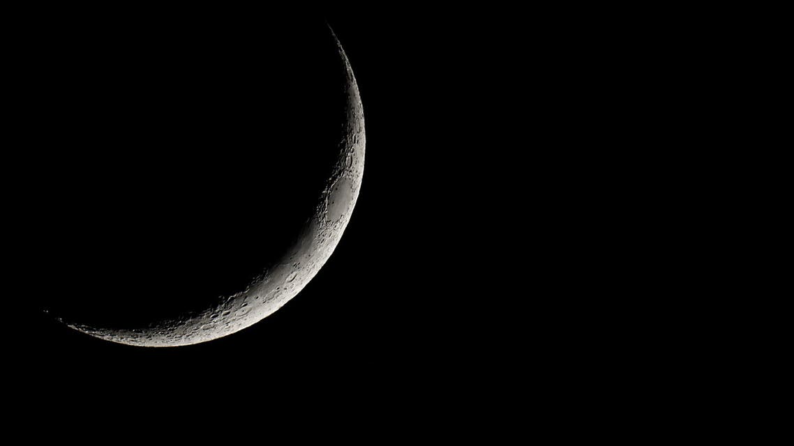 A waxing crescent moon rises over the town of Elefsina, Greece, June 13, 2021. (Reuters)