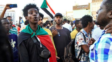 Sudanese protesters take part in a rally against military rule before breaking their fast with a collective Iftar meal on April 11, 2022 in the capital Khartoum during the Muslim holy month of Ramadan. (AFP)