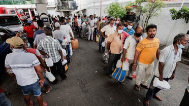 People wait in a line to buy petrol at a Ceylon Ceypetco fuel station on a main road, amid the country’s economic crisis in Colombo, Sri Lanka, on April 12, 2022. (Reuters)