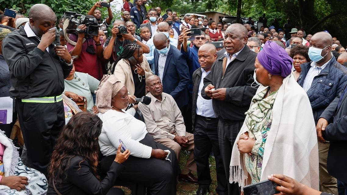 South African President Cyril Ramaphosa (2nd R) and Minister of Cooperative Governance and Traditional Affairs of South Africa, Nkosazana Dlamini Zuma (R), speak to various grieving family members at the United Methodist Church of South Africa in Clermont, near Durban, on April 13, 2022. (AFP)