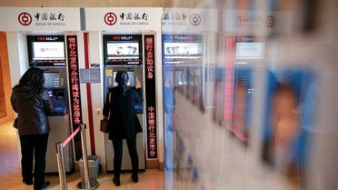 People use ATMs inside the Bank of China head office building in Beijing, China.  (File photo: Reuters)