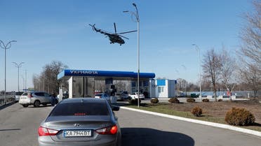 Ukrainian military helicopter flies over a gas station, after Russian President Vladimir Putin authorized a military operation in eastern Ukraine, outside the city of Dnipro, Ukraine on February 24, 2022. (Reuters)