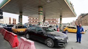 Iraqis crowd a petrol station to refuel amid a dispute between the authorities and owners of private stations, in Baghdad on April 14, 2022. (AFP)