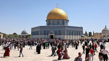 Palestinian Muslims gather at Jerusalem's Al-Aqsa Mosque complex following Friday prayers, April 15, 2022. (AFP)