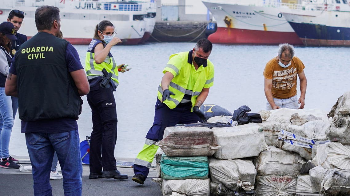 Police officers discharge drugs from the fishing boat AKT-1 seized south of the Canary Islands in the port of Las Palmas, in the island of Gran Canaria, Spain, April 16, 2022. REUTERS/Borja Suarez