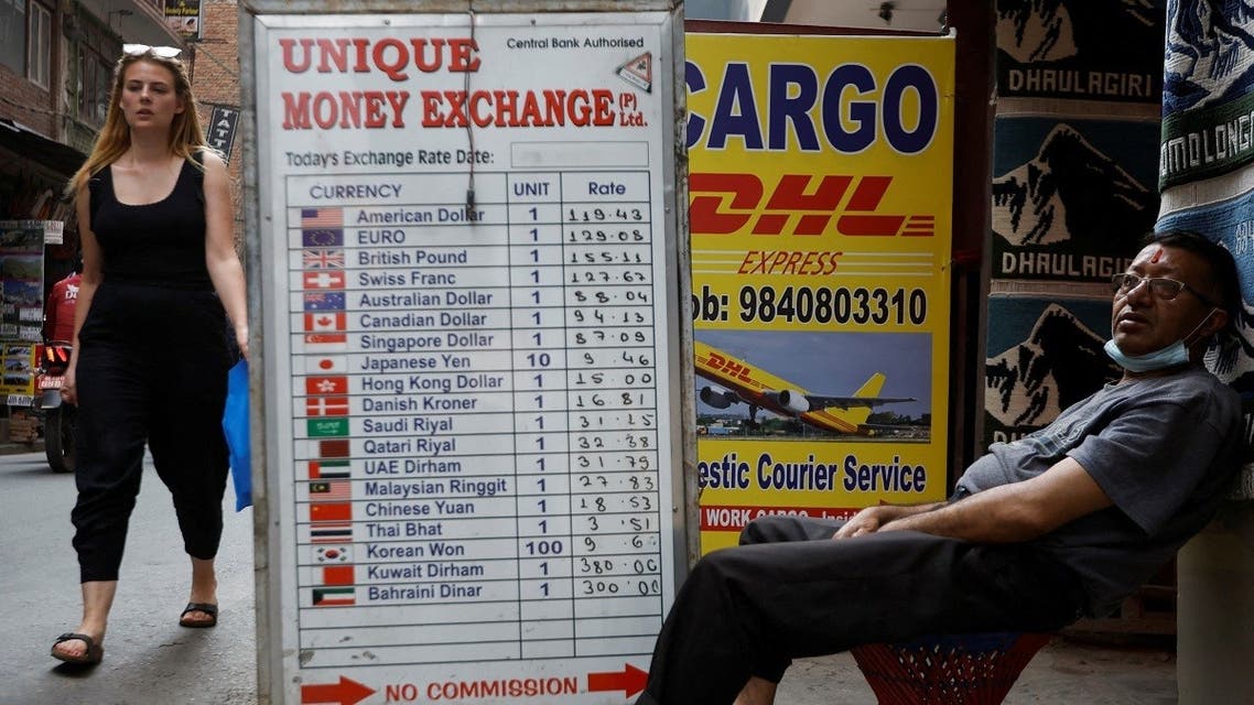 A man sits outside a money exchange at Thamel, a major tourist hub, as government tightens imports of cars, gold and cosmetics after the foreign exchange reserves have fallen in Kathmandu, Nepal, on April 12, 2022. (Reuters)