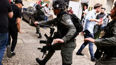 Israeli border police chase Palestinian youths in Jerusalem's Old City, on April 17, 2022. (AFP)