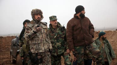 Syrian pro-government fighters, led by Colonel Suheil al-Hassan (L), known as the 'Nimr', Arabic for Tiger, hold a position near the Syrian village of Al-Najjarah, east of the northern Syrian city of Aleppo on January 7, 2016 as regime forces have recaptured several areas in the north of the country from Islamist jihadists. Eastern parts of Aleppo province are held by the Islamic State jihadist group, and the west is held by opposition groups ranging from US-backed rebels to Al-Nusra. AFP PHOTO / GEORGE OURFALIAN (Photo by GEORGE OURFALIAN / AFP)