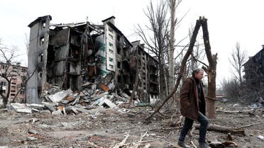 A man walks near a residential building destroyed during Ukraine-Russia conflict in the southern port city of Mariupol, Ukraine April 17, 2022. (Reuters)