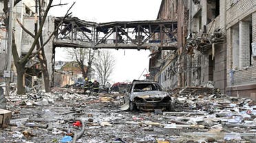 Rescuers sift through the debris of buildings destroyed following bombardment, killing two people and injuring eighteen others according to the prosecutors' office of Kharkiv region, in the Ukrainian city of Kharkiv on April 16, 2022. (AFP)