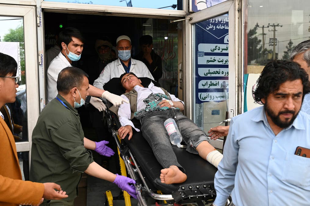 Medical staff move a wounded youth on a stretcher inside a hospital after three blasts rocked a boys' school in a Shiite Hazara neighbourhood in Kabul on April 19, 2022. (AFP)