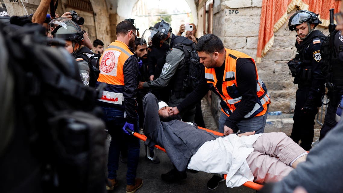 Rescue personnel evacuate an injured man outside the compound that houses Al-Aqsa Mosque, known to Muslims as Noble Sanctuary and to Jews as Temple Mount, in Jerusalem's Old City April 17, 2022. (Reuters)