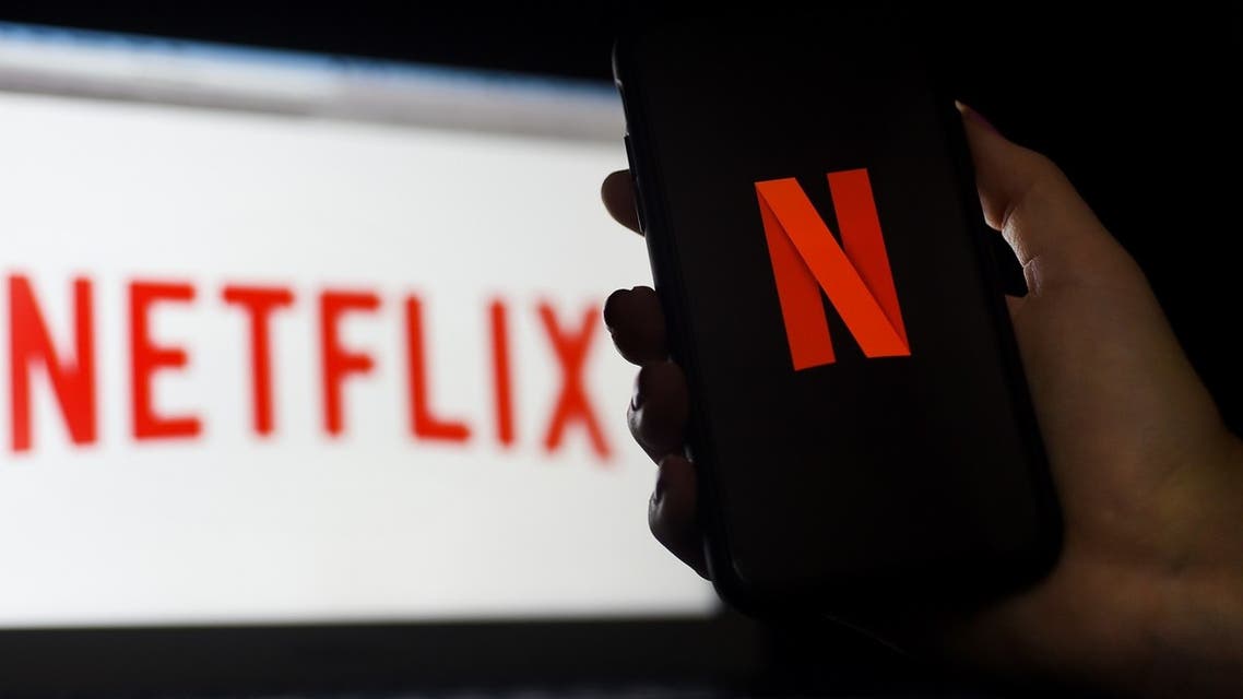 In this photo illustration a computer and a mobile phone screen display the Netflix logo on March 31, 2020 in Arlington, Virginia. (AFP)