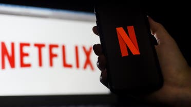In this photo illustration a computer and a mobile phone screen display the Netflix logo on March 31, 2020 in Arlington, Virginia. (AFP)