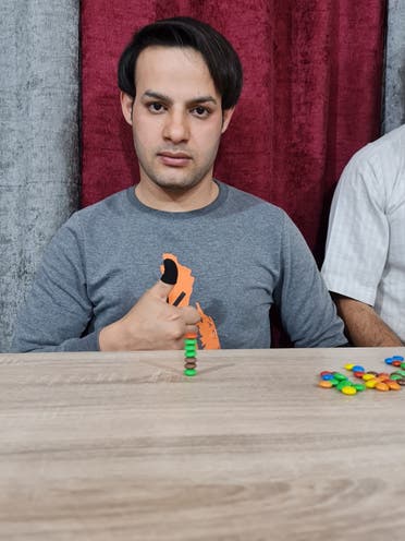 Ibrahim Sadeq on April 7, 2022, where he stacked the M&Ms on top of each other in under two minutes. (Supplied)