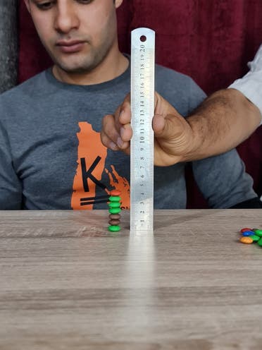 Ibrahim Sadeq on April 7, 2022, where he stacked the M&Ms on top of each other in under two minutes. (Supplied)