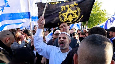 Israeli protesters wave national and party flags as they march toward Tzahal square on April 20, 2022, during the ‘flags march’ organized by nationalist parties. (AFP)