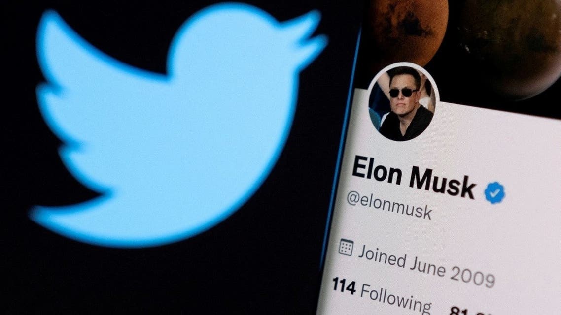Elon Musk’s Twitter account is seen on a smartphone in front of the Twitter logo in this photo illustration taken on April 15, 2022. (Reuters)
