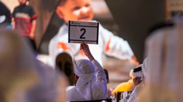 A man makes a bid at the second Most Noble Numbers auction in Abu Dhabi's Emirates Palace. (WAM)