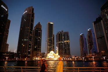 Tourist take photos of a mosque across the Dubai Marina, surrounded by high towers of hotels, banks and office buildings, in Dubai, United Arab Emirates December 11, 2017. (File photo: Reuters)