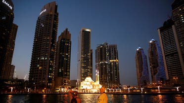 Tourist take photos of a mosque across the Dubai Marina, surrounded by high towers of hotels, banks and office buildings, in Dubai, United Arab Emirates December 11, 2017. (File photo: Reuters)