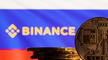 A representation of the cryptocurrency is seen in front of the Binance logo and Russian flag in this illustration taken, March 4, 2022. (Reuters)