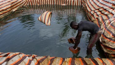 A man collects crude oil from a mini depot at an illegal oil refinery site near river Nun in Nigeria’s oil state of Bayelsa on November 27, 2012. (File photo: Reuters)