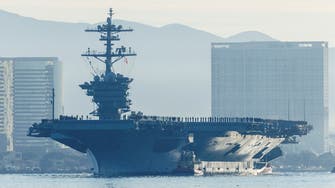 Japan’s foreign minister promises a stronger military during visit to US carrier
