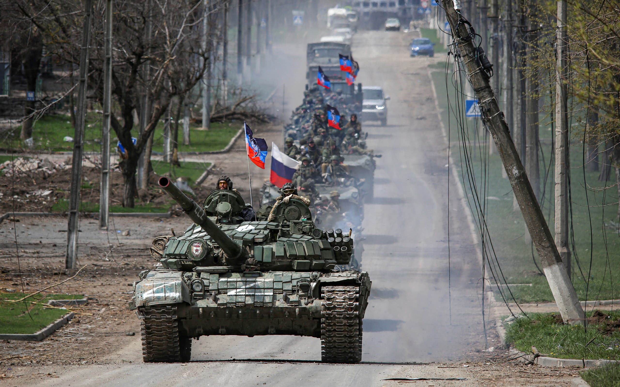 An armored convoy of pro-Russian forces moves along a road in Mariupol (Reuters)