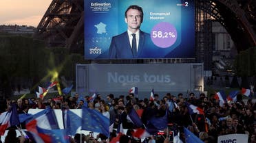 Supporters of French President Emmanuel Macron, candidate for his re-election, wave French and European Union flags, as they react after the results in the second round vote of the 2022 French presidential election, near Eiffel Tower, at the Champs de Mars in Paris, France April 24, 2022. (Reuters)