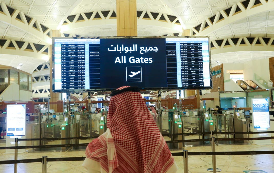 FILE PHOTO: A Saudi man checks the flight timings at the King Khalid International Airport in Riyadh, Saudi Arabia, May 16, 2021. REUTERS/Ahmed Yosri/File Photo
