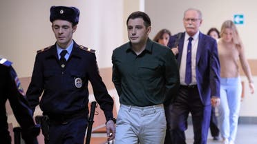 US ex-Marine Trevor Reed, who was detained in 2019 and accused of assaulting police officers, is escorted before a court hearing in Moscow, Russia, on March 11, 2020. (Reuters)