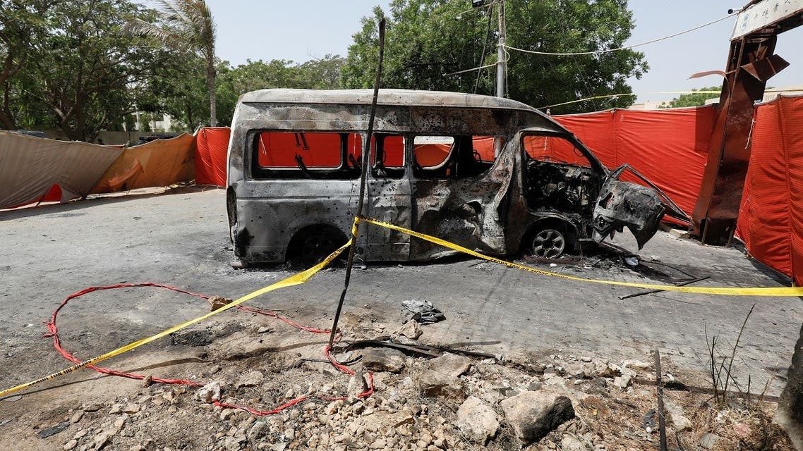 A view of the crater and cordoned area near a damaged passenger van, a day after a suicide blast, at the entrance of the Confucius Institute University of Karachi, Pakistan, on April 27, 2022. (Reuters)