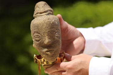 A newly-discovered stone statuette over 4,500 years old depicting the face of an ancient goddess, is displayed during a press conference at the Ministry of Antiquities and Tourism in Gaza City on April 26, 2022. (Photo by MOHAMMED ABED / AFP)