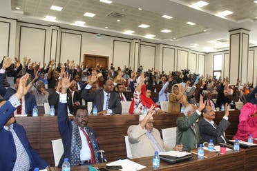 Somali members of Parliament raise their hands to approve the new Somali Prime Minister Mohamed Hussein Roble, a Swedish-trained civil engineer, in Mogadishu, Somalia, on September 23, 2020. (AFP)