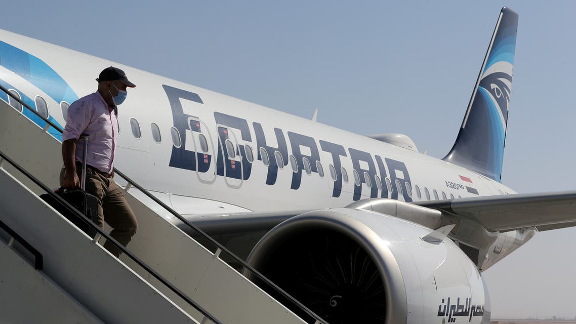 A traveler wearing a protective face mask disembarks from an EgyptAir plane, following an outbreak of the coronavirus disease (COVID-19), at Hurghada International Airport in Hurghada, Egypt, June 18, 2020. (File photo: Reuters)