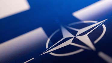 Finnish and NATO flags are seen printed on paper this illustration taken April 13, 2022. (Reuters)