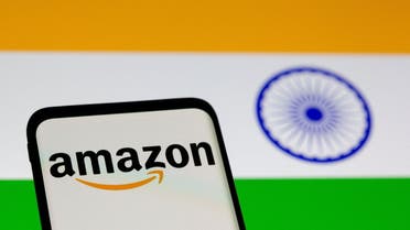 martphone with Amazon logo is seen in front of displayed Indian flag in this illustration taken, July 30, 2021. (Reuters)